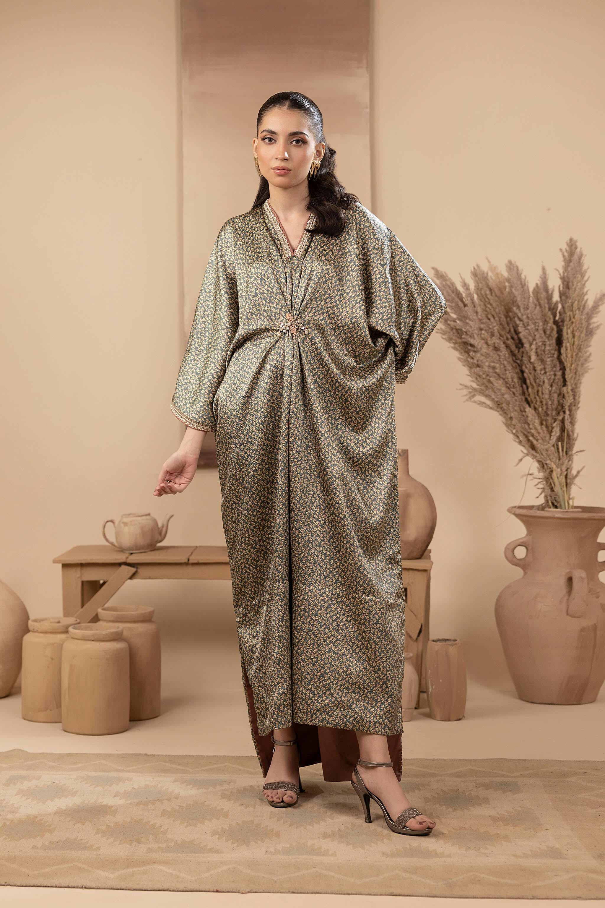 Greenish printed silk kaftan with hand embellished neckline, sleeves and embellished brooch.