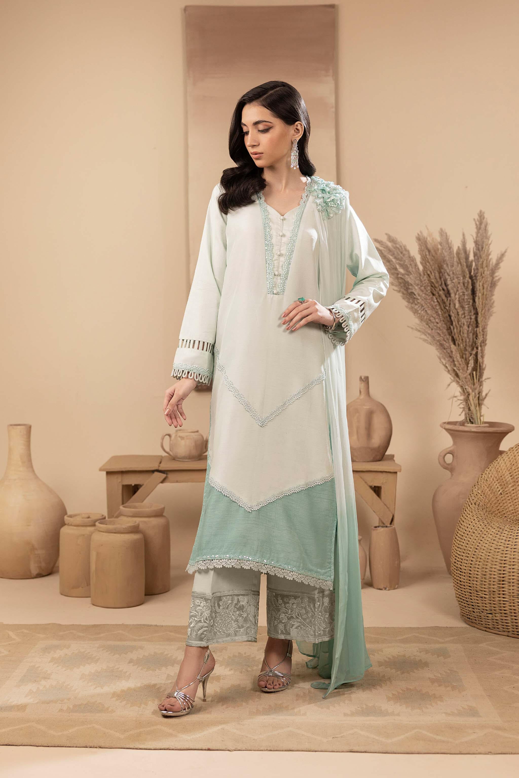 The silk shirt has an embellished neckline, and 3-D hand-embellished motifs. It is accompanied by detachable dupatta and embroidered ombre-effect trousers.