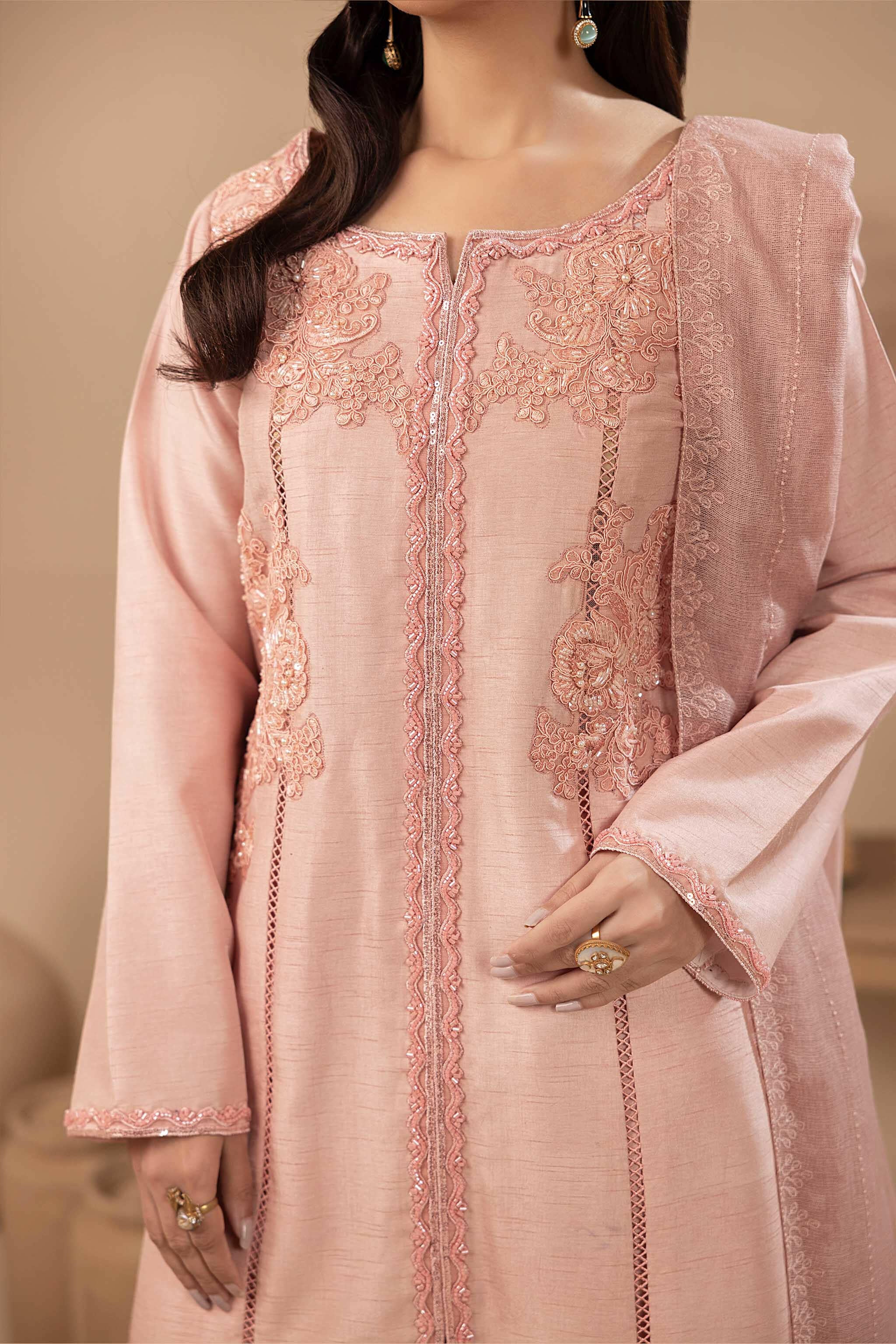 Pink silk shirt with hand embellishments, while the well-tailored sleeves and matching trouser ensure a flawless fit.