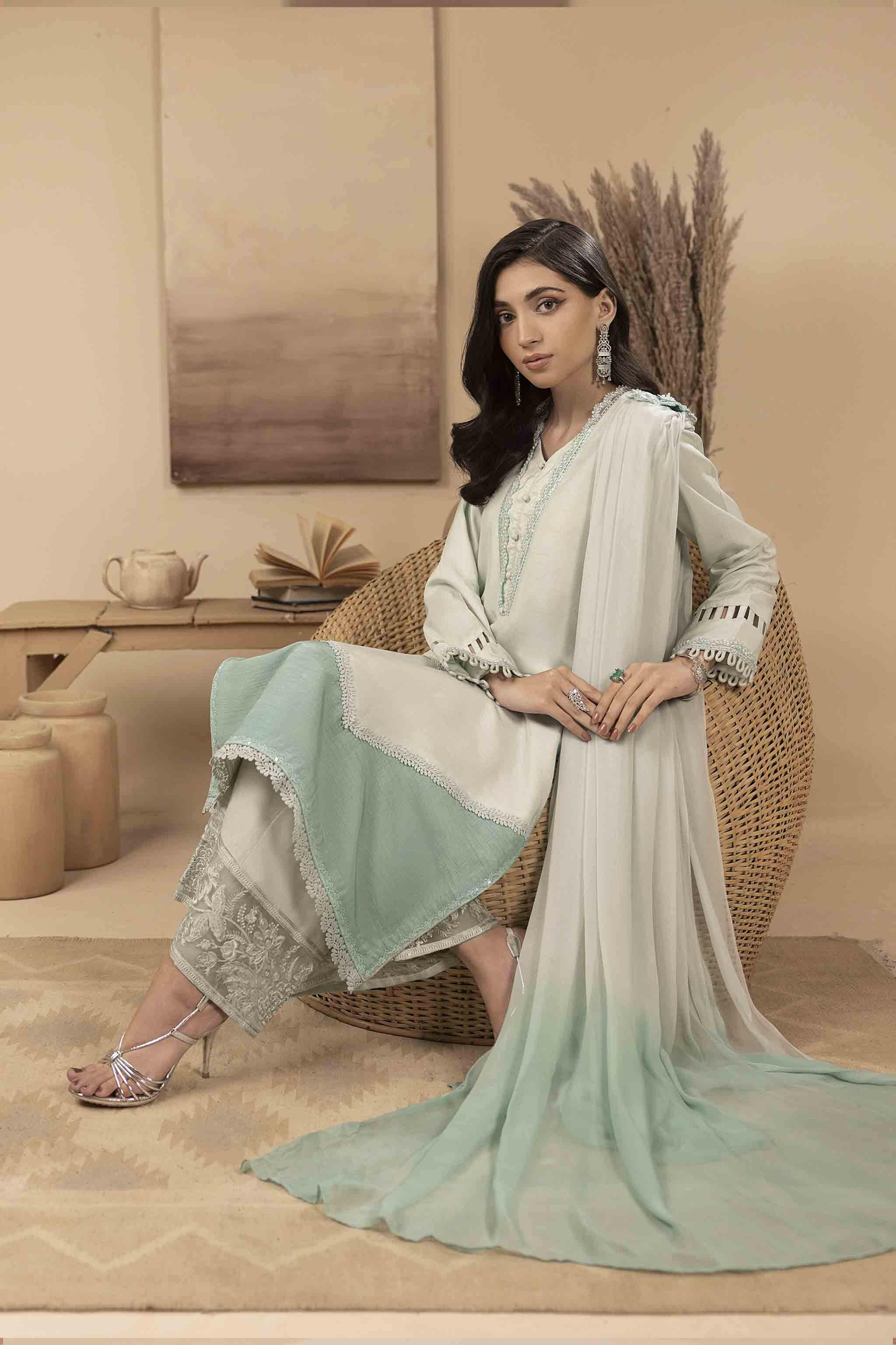 The silk shirt has an embellished neckline, and 3-D hand-embellished motifs. It is accompanied by detachable dupatta and embroidered ombre-effect trousers.